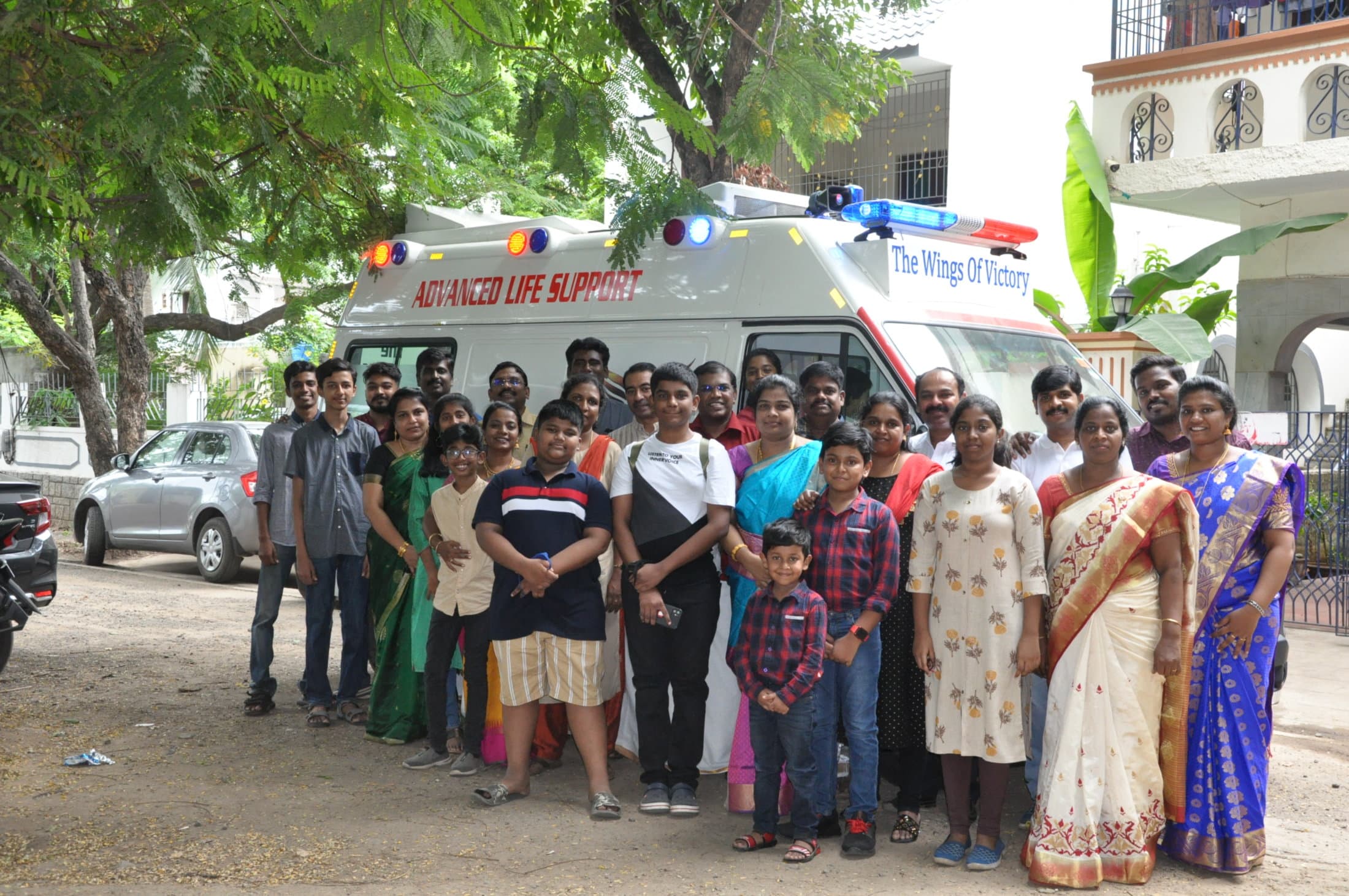 Families gathered beside the trust's ambulance on the day it began service.