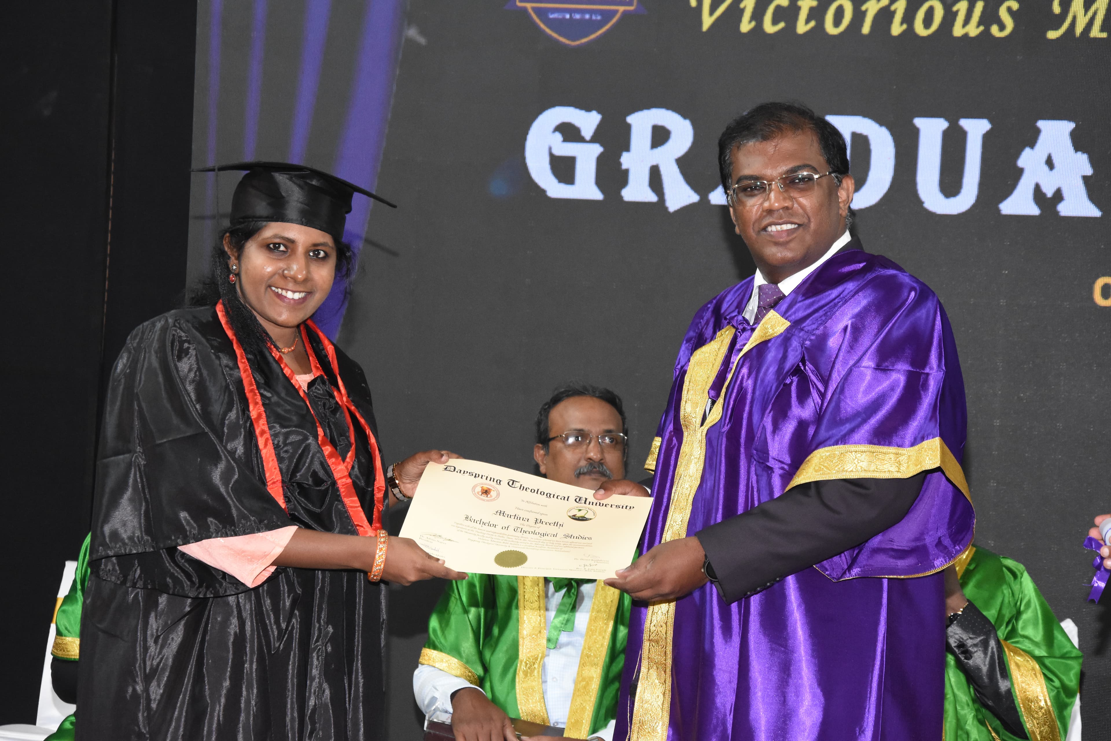A graduand receiving her certificate at a Bible Institute graduation.